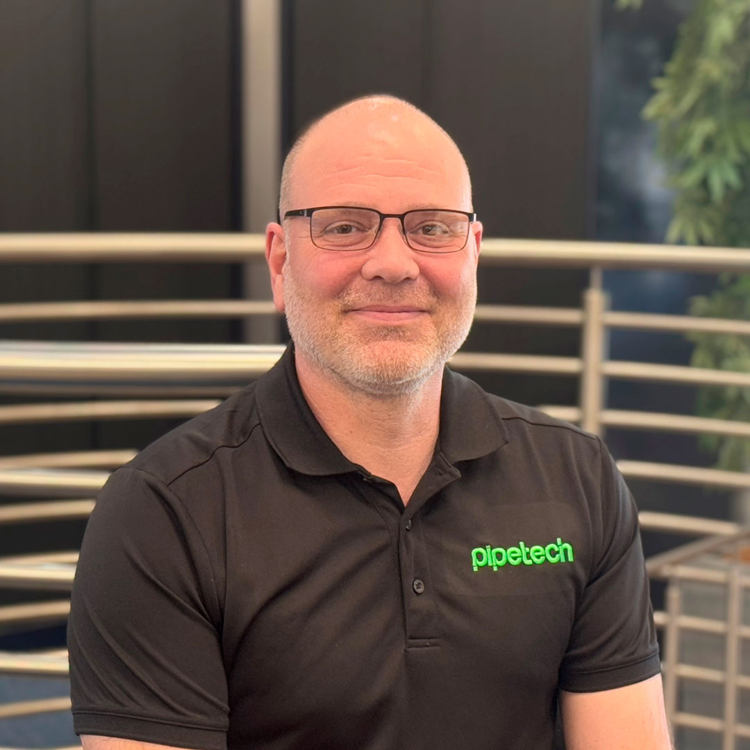 A bald man wearing a black branded t-shirt.