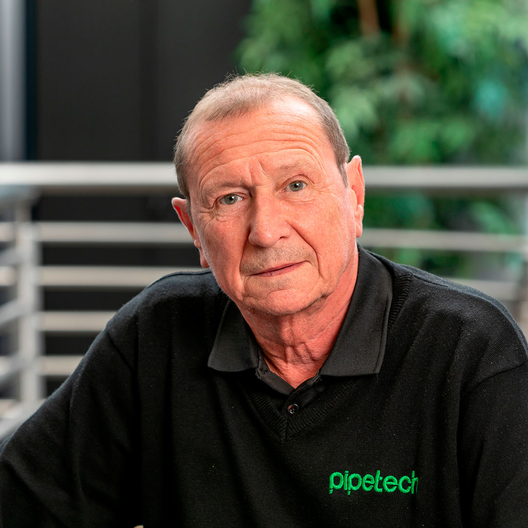 Man with brown hair wearing a black branded t-shirt.